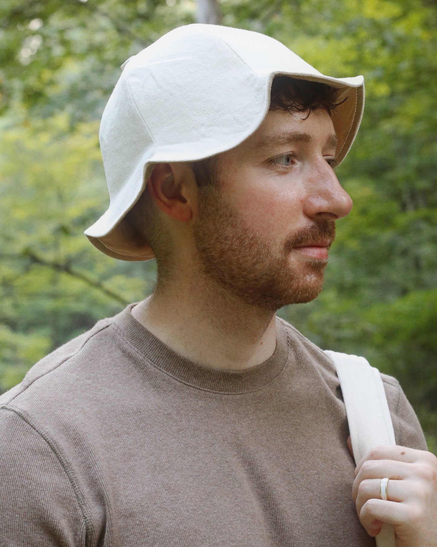 Man wearing an ivory bucket hat outdoors