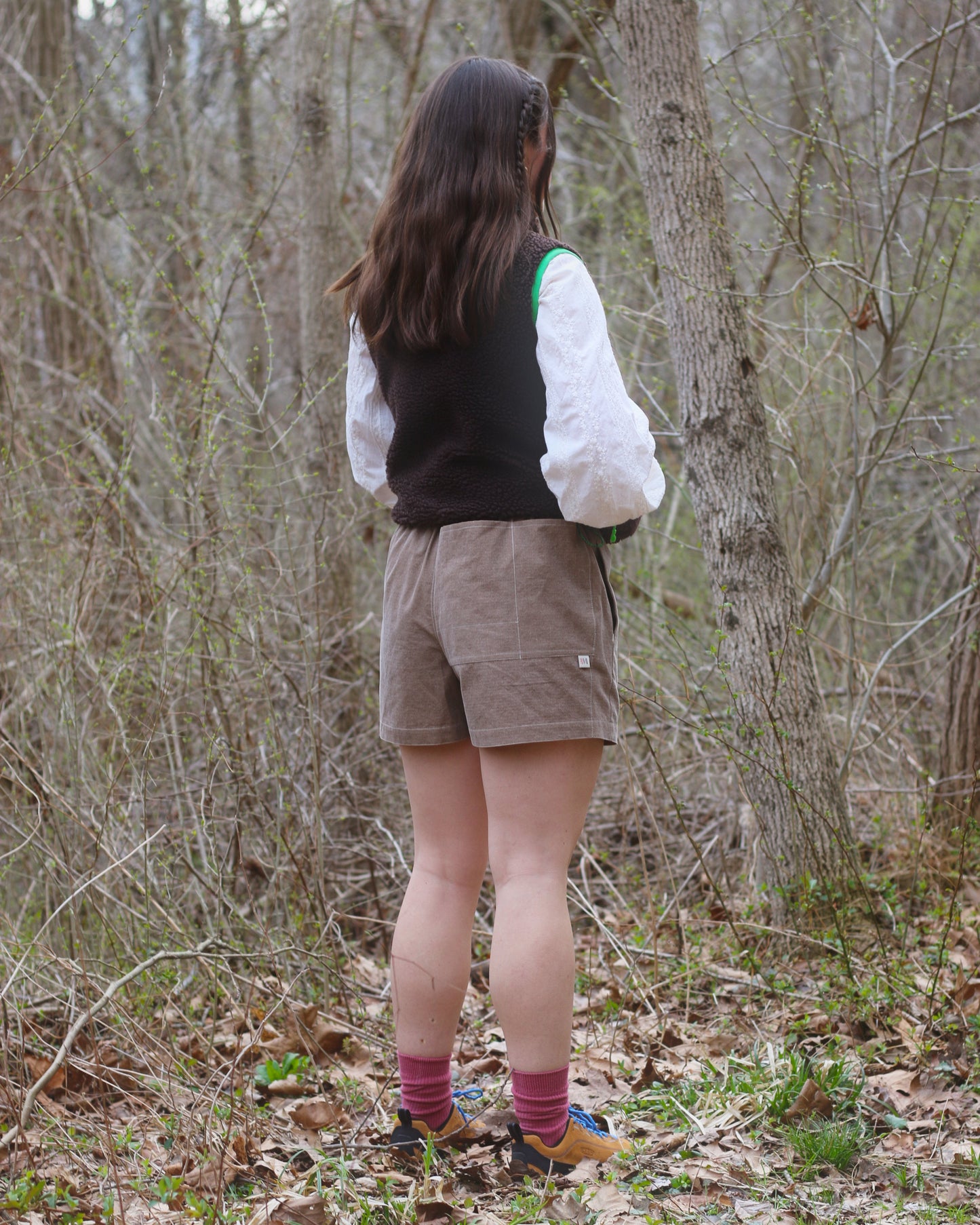 Women wearing brown shorts in the woods