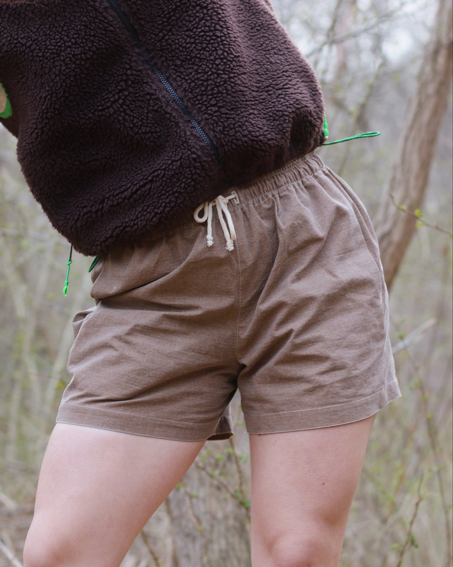 Women wearing brown shorts with drawcord waistband