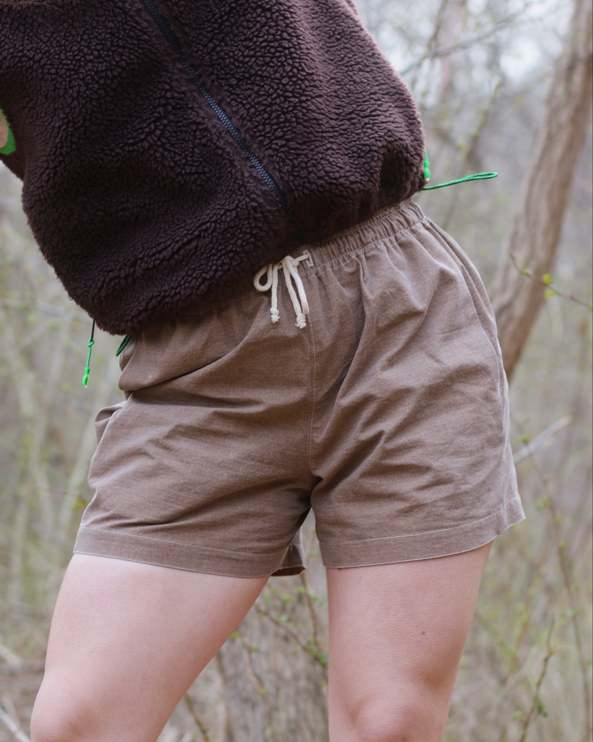 Women wearing brown shorts with drawcord waistband